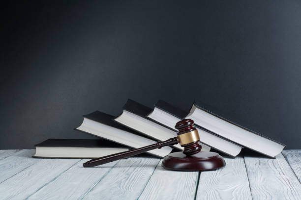 A judge 's gavel and some books on the floor.