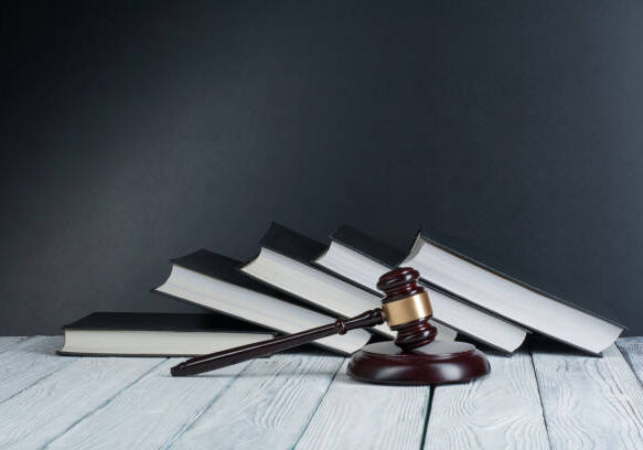 A judge 's gavel and some books on the floor.